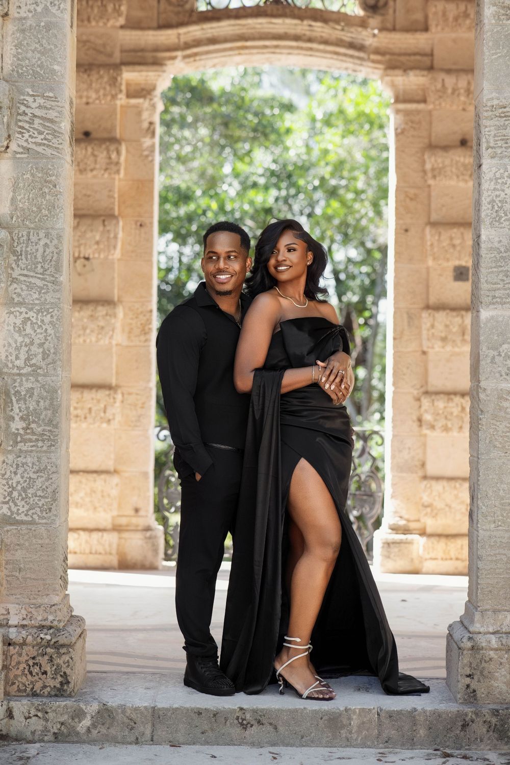 Couple beside a stone column, bride in red