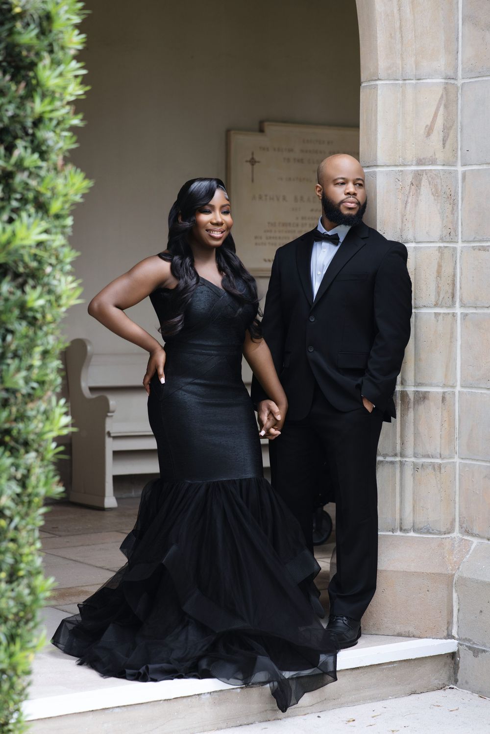 Couple standing before a stately facade