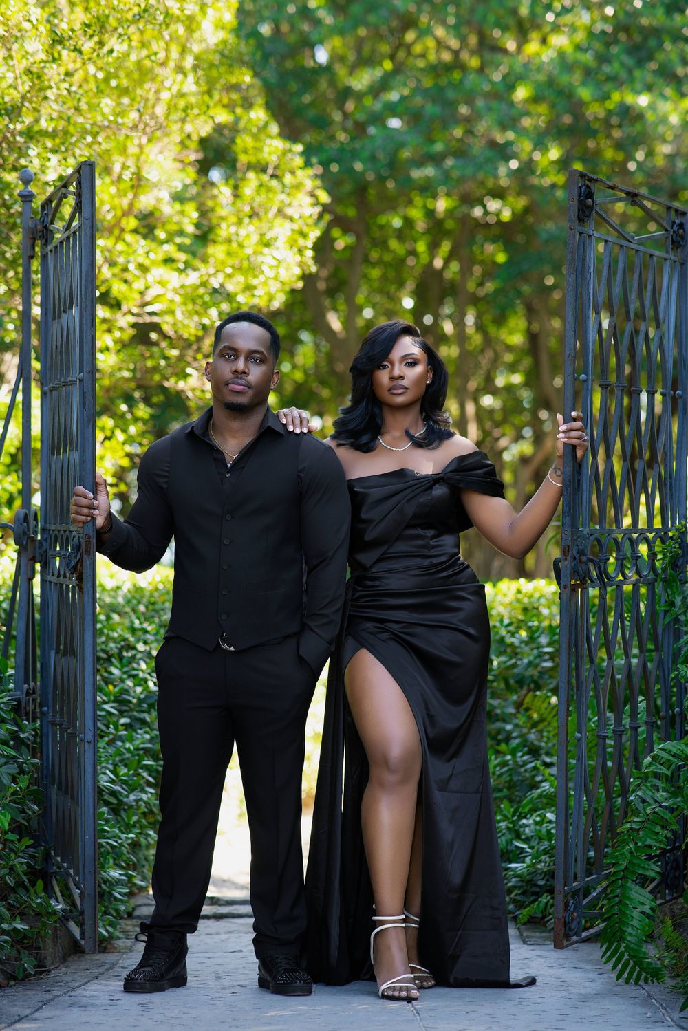 Couple framed by an ornate iron gate