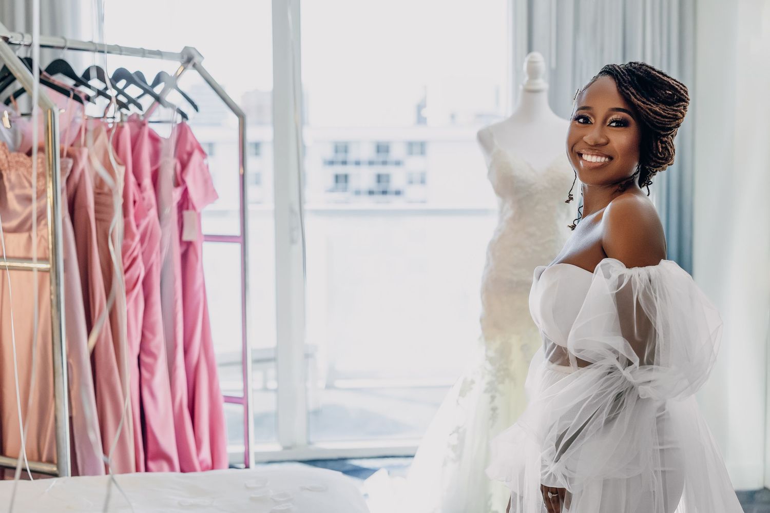 Bride laughing while the dresses are brought out