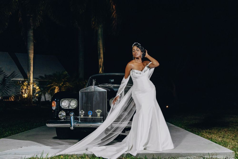 Couple with a vintage car after dark