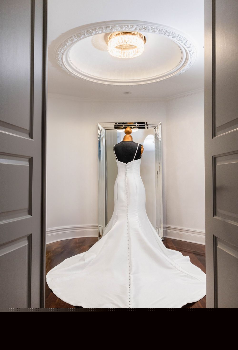 Bride in a doorway with her train behind her
