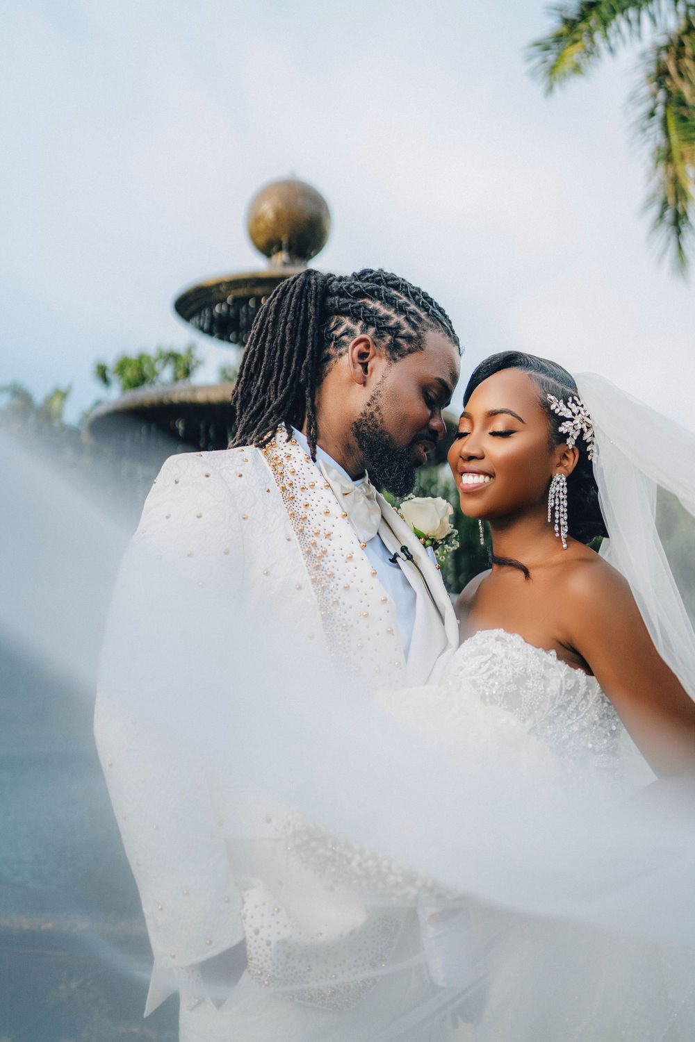 Couple together beneath the veil